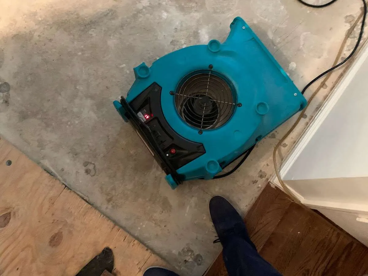 Air mover drying subfloor during Commercial Water Damage Restoration in Oak Ridge